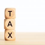 Tax word in wooden blocks on table